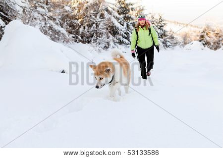Woman Winter Hiking With Dog