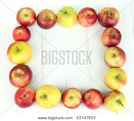 Juicy apples on white wooden table