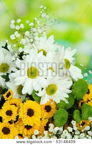 Beautiful flowers on table on bright background