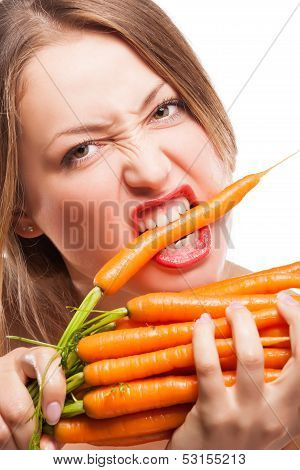attractive woman holds bunch of carrots
