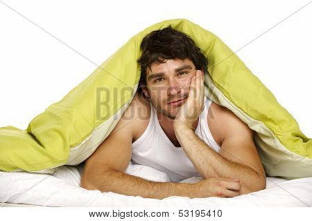 Man In Bed Under A Green Duvet