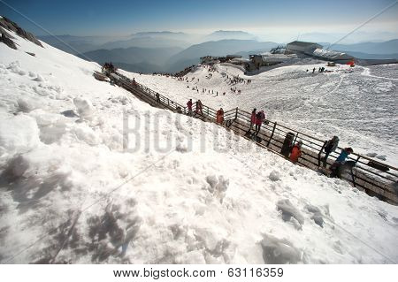 Groups Of Traveler On Wooden Stair Of Jade Dragon Snow Mountain,lijiang,yunan,southwestern China.