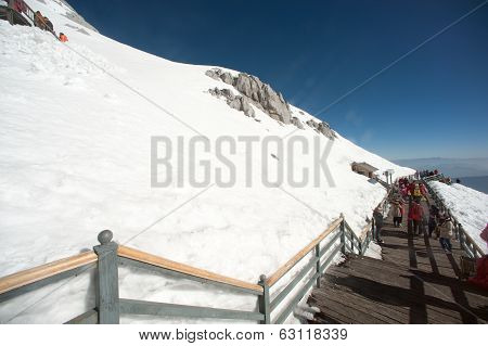 Wooden Stair And Traveler On Jade Dragon Snow Mountain,lijiang,yunan,southwestern China.
