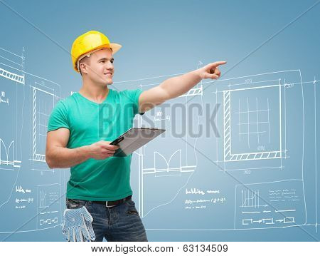 repair, construction and maintenance concept - smiling man in helmet with clipboard pointing finger