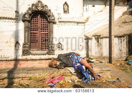 KATHMANDU, NEPAL - DEC 3, 2013: Unidentified local man during the cremation ceremony along the holy Bagmati River in Bhasmeshvar Ghat at Pashupatinath temple in Kathmandu.