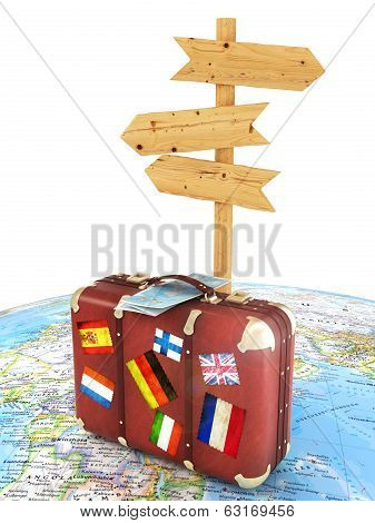 wood sign board and old suitcase with striples flags on blurred world map