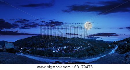 Village On Hillside Of Mountain At Night
