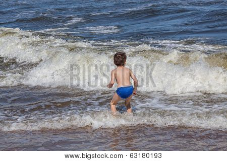 Kid Playing On A Beach