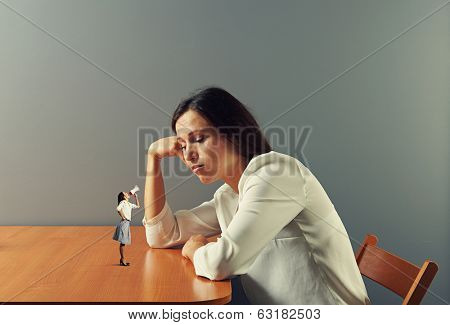 small woman urging on tired businesswoman