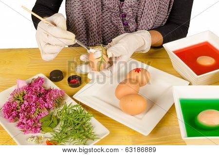 Hands decorating Easter eggs