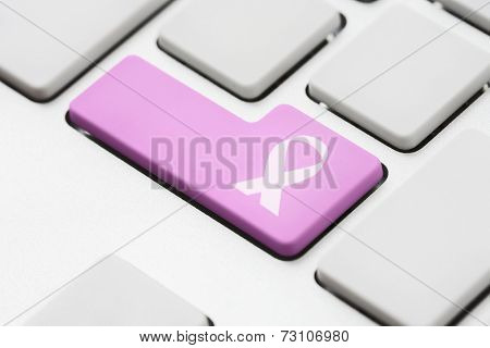 Cancer ribbon symbol on computer key