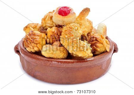 an earthenware bowl with panellets, typical pastries of Catalonia, Spain, eaten in All Saints Day, on a white background