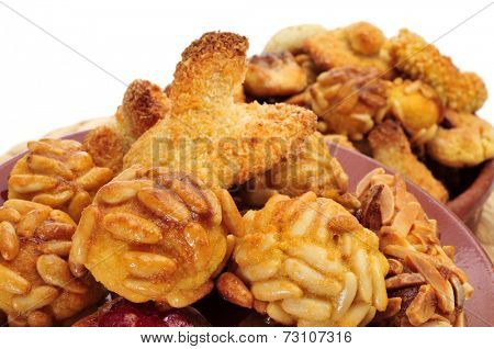 closeup of a pile of panellets, typical pastries of Catalonia, Spain, eaten in All Saints Day, on a white background