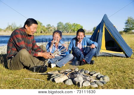 Mongolian family anjoy camping by the river.