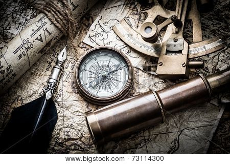 vintage  still life with compass,sextant spyglass and old map.map used for background is in Public domain. Map source: Library of Congress. Belgium Year: 1570 Author Abraham Ortelius 1527-1598 