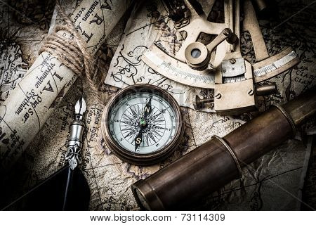 vintage  still life with compass,sextant spyglass and old map.map used for background is in Public domain. Map source: Library of Congress. Belgium Year: 1570 Author Abraham Ortelius 1527-1598 