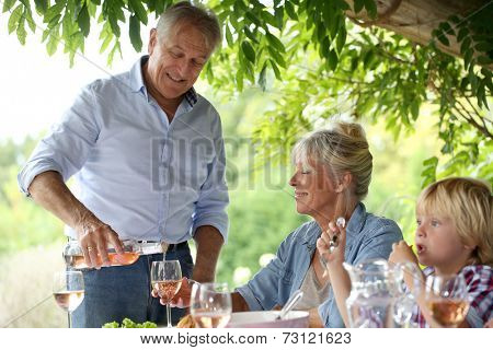Family having summmer lunch in country house