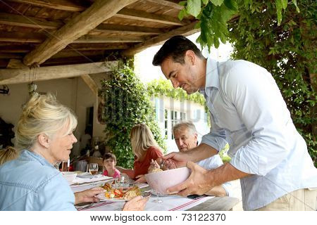 Family having summmer lunch in country house