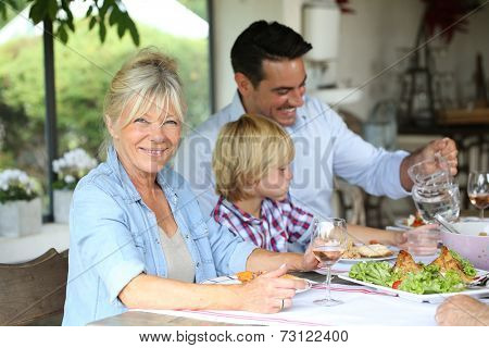 Family having summmer lunch in country house