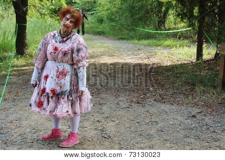 MUSKOGEE, OK - Sept. 13: A bloody male zombie waits for the next runner to chase during the Castle Zombie Run at the Castle of Muskogee in Muskogee, OK on September 13, 2014. 
