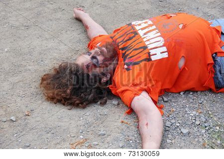 MUSKOGEE, OK - Sept. 13: A bloody male zombie waits for the next runner to chase during the Castle Zombie Run at the Castle of Muskogee in Muskogee, OK on September 13, 2014. 
