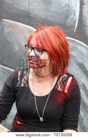 MUSKOGEE, OK - Sept. 13: A bloody male zombie waits for the next runner to chase during the Castle Zombie Run at the Castle of Muskogee in Muskogee, OK on September 13, 2014. 