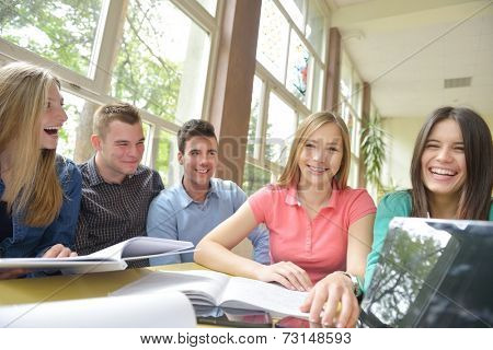 happy young teens group in school on chemisty lessons and library education
