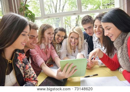 happy young teens group in school on chemisty lessons and library education