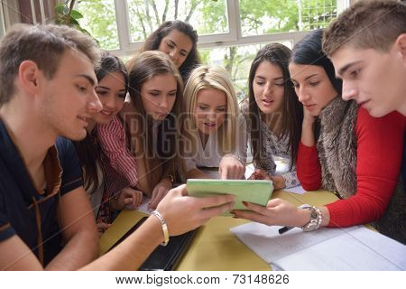 happy young teens group in school on chemisty lessons and library education