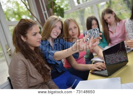 happy young teens group in school on chemisty lessons and library education