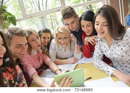 happy young teens group in school on chemisty lessons and library education