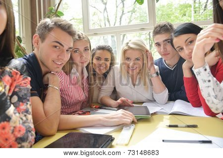 happy young teens group in school on chemisty lessons and library education