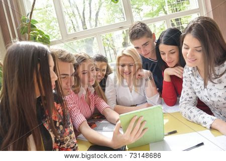 happy young teens group in school on chemisty lessons and library education