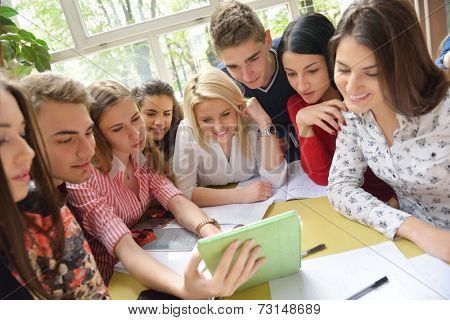 happy young teens group in school on chemisty lessons and library education