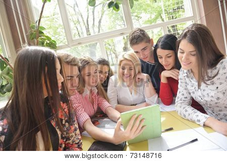happy young teens group in school on chemisty lessons and library education