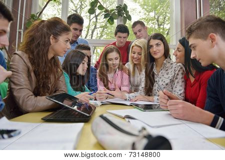 happy young teens group in school on chemisty lessons and library education