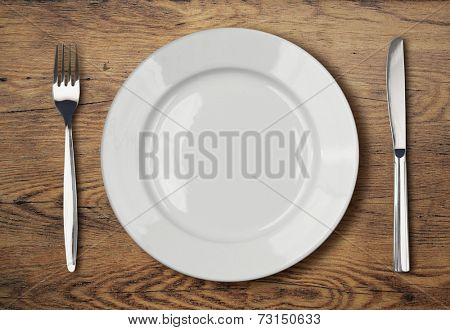 white empty dinner plate setting on table