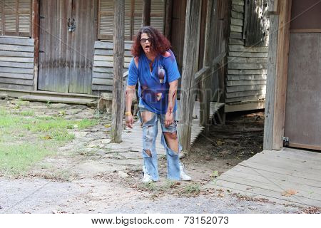 MUSKOGEE, OK - Sept. 13: A bloody female zombie waits for runners during the Castle Zombie Run at the Castle of Muskogee in Muskogee, OK on September 13, 2014. 