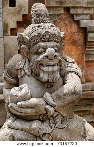 Stone sculpture of Balinese Hindu god inside the Tirta Empul Temple.
