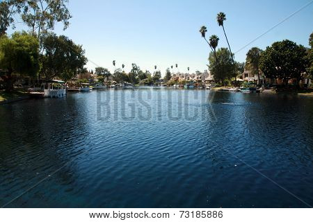 Private Lake with homes and boats in Lake Forest California. Lake Forest has many Private Lakes with limited access to the general public, making it an ideal and serene location to live life.