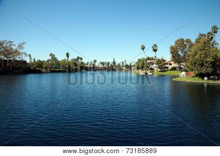 Private Lake with homes and boats in Lake Forest California. Lake Forest has many Private Lakes with limited access to the general public, making it an ideal and serene location to live life.