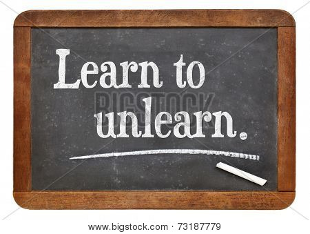 learn to unlearn - advice or motivation words on a vintage slate blackboard