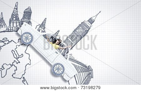 Young woman riding car made of list of paper