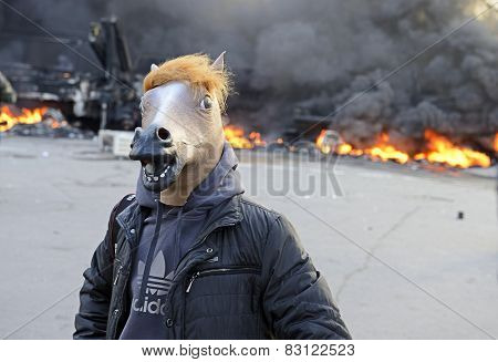 Protestor In Mask On  Ablaze Car Background