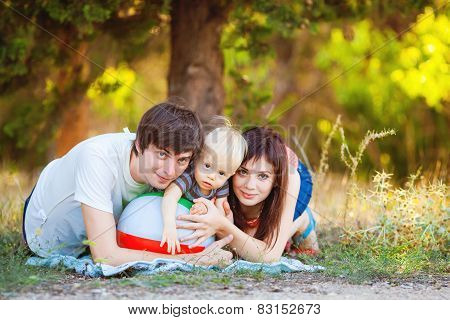 Happy young family spending time outdoor on a summer day