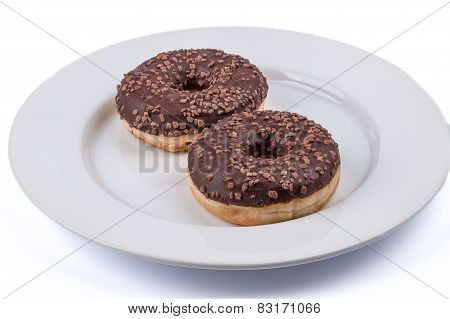Two Ring Donuts With Chololate Glaze On White Plate