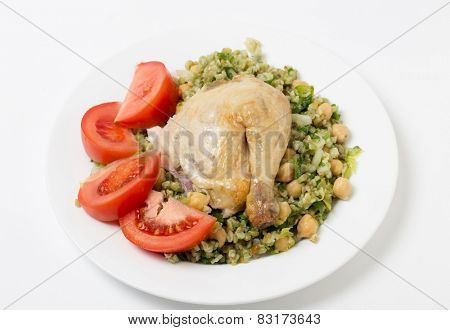 Freekeh salad with chickpeas, onion, parsley, celery, and a lemon juice and olive oil dressing, and a chicken leg with tomato
