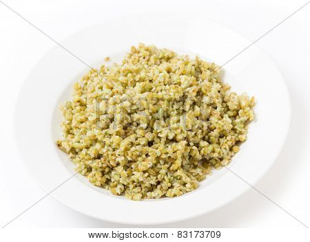 A bowl of freshly boiled cracked freekeh scorched green wheat grains, one of the 