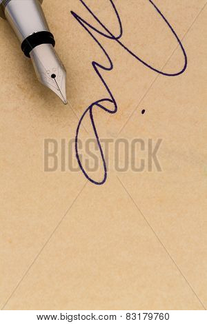 a signature and a fountain pen on yellow paper. symbolic photo for contract, testament and graphology
