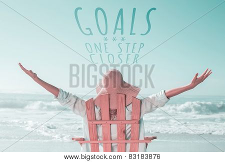 Woman relaxing in deck chair by the sea against goals one step closer